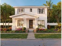 Charming two-story home featuring a welcoming front porch with columns and beautifully landscaped yard at 1435 17Th N Ave, St Petersburg, FL 33704