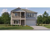 Charming two-story home with a welcoming covered entry, a two car garage, and tastefully landscaped front yard at 18461 Serene Lake Loop, Lutz, FL 33548