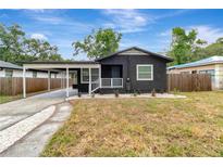 Charming single-story home featuring a carport and well-maintained front yard at 1914 E Emma St, Tampa, FL 33610