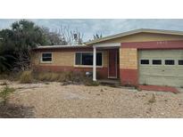 Modest single-story home with mixed brick and painted facade and an attached single-car garage at 2817 Miriam S St, Gulfport, FL 33711