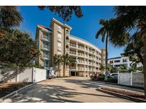 Elegant building featuring multiple balconies and well-maintained landscaping at 3805 Gulf Blvd # 504, St Pete Beach, FL 33706