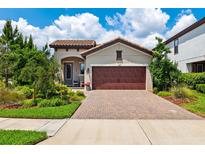 Charming single-story home with a beautiful paver driveway and manicured landscaping at 3877 Burdick Loop, Odessa, FL 33556