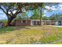 Charming single-story brick home featuring a well-maintained lawn and mature trees for ample shade at 4512 24Th Ave S, Tampa, FL 33619