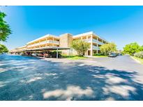Condo complex with covered parking, mature trees, and well-maintained landscaping on a bright day at 4885 1St Ne St # 110, St Petersburg, FL 33703