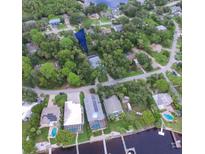 Scenic aerial view showcasing the home's location amidst lush trees and waterway access at 5153 Miller Bayou Dr, Port Richey, FL 34668