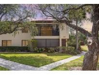Two-story condo with landscaped lawn and garden at 5666 Gardens Dr # 202, Sarasota, FL 34243