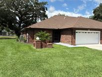 Charming single story brick home with an attached garage and manicured lawn at 6533 Brentwood Dr, Zephyrhills, FL 33542