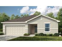 Charming single-story home featuring a two-car garage and manicured front lawn at 13556 Tropical Breeze Way, Hudson, FL 34669