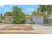 Charming single Gathering home with a stone accent garage and mature landscaping in a desirable location at 1472 Belcher S Rd, Largo, FL 33771