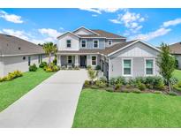 Beautiful two-story home boasts a manicured lawn, long driveway, and lovely landscaping at 16115 Mount Holly Dr, Bradenton, FL 34211