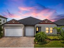 Charming single-story home with a three-car garage and well-maintained landscaping at 21648 Snowy Orchid Ter, Land O Lakes, FL 34637