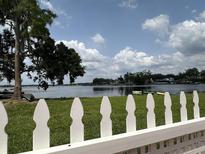 Backyard with white picket fence that overlooks a lake at 2557 Cedar Cypress Ct, Tampa, FL 33618