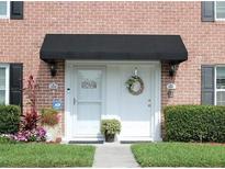 Charming front door with black awning, decorative wreath and love sign provides a welcoming entrance at 2557 Cedar Cypress Ct, Tampa, FL 33618