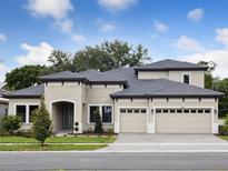 Stunning two-story home with a three-car garage, neutral stucco, and a meticulously manicured lawn at 4630 Cedar Fog Ct Dr, Valrico, FL 33596