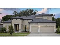 Stunning two-story home featuring a neutral palette, well-manicured landscaping, a gray roof, and a two-car garage at 4630 Cedar Fog Ct Dr, Valrico, FL 33596