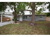 Charming single-story home with a covered carport and well-maintained front yard and mature trees at 5205 98Th N Ter, Pinellas Park, FL 33782