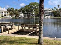 Waterfront view from the private dock with seating, providing scenic views of the surrounding neighborhood at 5445 Manatee Point Dr, New Port Richey, FL 34652