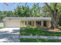 Charming single-story home with a well-manicured lawn and a two-car garage at 606 Brentwood Pl, Brandon, FL 33511