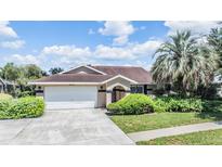 Charming single Gathering home featuring a well maintained lawn and a two car garage at 6436 Huntington Dr, Zephyrhills, FL 33542