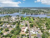 Aerial view showcasing the property's location, nearby lake, and surrounding neighborhood at 9917 Prevatt St, Gibsonton, FL 33534