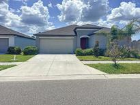 Charming single-story home featuring a neutral color palette, a two-car garage, and well-maintained landscaping at 11524 Sage Canyon Dr, Riverview, FL 33578