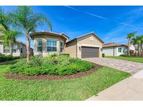 Beautiful single-Gathering home showcasing a well-maintained lawn and lush landscaping at 15525 Corona Del Mar Dr, Wimauma, FL 33598