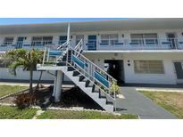 Charming two-story apartment complex with well-maintained grounds, stairs to second level, and a tropical palm tree at 2011 58Th N Ave # 20, St Petersburg, FL 33714