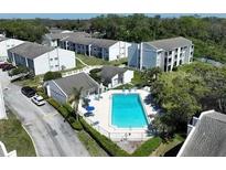 Scenic aerial view of the community featuring a refreshing pool and well-maintained apartment buildings at 2625 State Road 590 # 2832, Clearwater, FL 33759