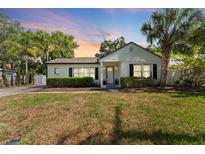 Charming single-story home showcasing manicured landscaping and an inviting facade with large windows at 3125 W Fielder St, Tampa, FL 33611