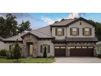 Charming two-story home with stone accents, a tile roof, a three-car garage, and manicured landscaping at 4523 Foley Grove Dr, Valrico, FL 33596