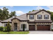 Charming two-story home with stone accents, a well-manicured lawn and a spacious two car garage at 4523 Foley Grove Dr, Valrico, FL 33596