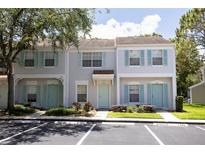 Charming townhome featuring a well-maintained exterior with colorful shutters and a lush green landscape at 8545 Hunters Key Cir, Tampa, FL 33647