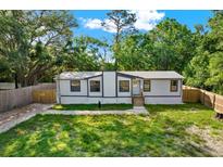 Charming single-story home with well-maintained lawn and natural surroundings providing a serene and private setting at 9690 Jerome Dr, New Port Richey, FL 34654