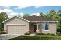 Charming single-story home featuring a neutral color palette, well-manicured lawn, and an attached two-car garage at 13621 Tropical Breeze Way, Hudson, FL 34669