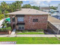 Charming brick apartment building with a pool, covered parking, and lush landscaping, near Davis Islands at 208 Danube Ave # 101, Tampa, FL 33606