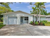 Charming single-story home with attached garage, well-maintained landscaping, and a welcoming entrance at 2575 Granada E Cir, St Petersburg, FL 33712