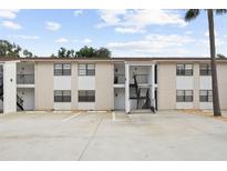 Apartment building exterior featuring multi-level access, parking, and neutral color scheme at 3102 W Horatio St # 13, Tampa, FL 33609