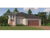 Charming single-Gathering home featuring a two-car garage, a modern design, and a well-manicured lawn at 31748 Griffin Sands Ln, San Antonio, FL 33576