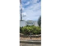 Westwind 55+ community sign with vibrant foliage at 3301 Alt 19 # 500, Palm Harbor, FL 34683