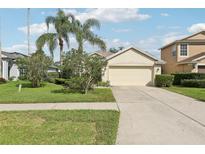 Charming single-story home featuring a well-manicured lawn and a two-car garage at 3311 Stonebridge Trl, Valrico, FL 33596