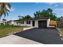 Charming single-story home with fresh exterior paint, driveway, and neatly landscaped front yard at 4624 83Rd Terrace N, Pinellas Park, FL 33781