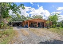 Charming single-story home with a spacious driveway and lush landscaping, providing a tranquil setting at 4858 Troydale Rd, Tampa, FL 33615