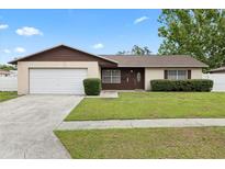 Charming one-story home with a well-maintained lawn and attached one car garage at 5213 Burr Pl, Seffner, FL 33584