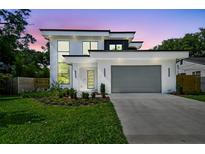 Modern two-story home with a two-car garage, sleek design, and well-manicured landscaping at 715 W Peninsular St, Tampa, FL 33603