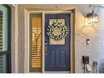 Charming front door adorned with a floral wreath, offering a warm welcome to visitors and enhancing curb appeal at 4222 Hartwood Ln # 1202, Tampa, FL 33618