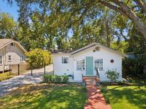 Charming home featuring a lovely brick pathway and a welcoming blue front door at 106 W Louisiana Ave, Tampa, FL 33603
