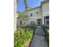Inviting exterior view of a two-story home with well-maintained landscaping and a gated front entrance at 10953 Winter Crest Dr, Riverview, FL 33569