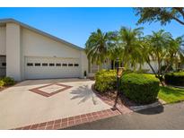 Well-maintained home exterior showcasing a driveway, garage, and lush landscaping for curb appeal at 1416 Leland Dr # 49, Sun City Center, FL 33573