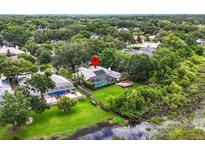 Beautifully landscaped property featuring pool, enclosed patio, and fenced yard at 16804 Windsor Park Dr, Lutz, FL 33549