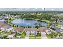 Aerial view of a lakeside community featuring beautiful homes and lush green landscaping at 5416 Camberwell Ln, Riverview, FL 33578